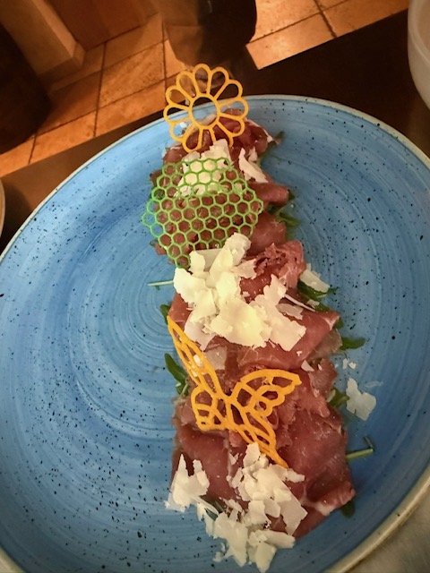 Angus Carpaccio auf Rucola Salat und Parmesan